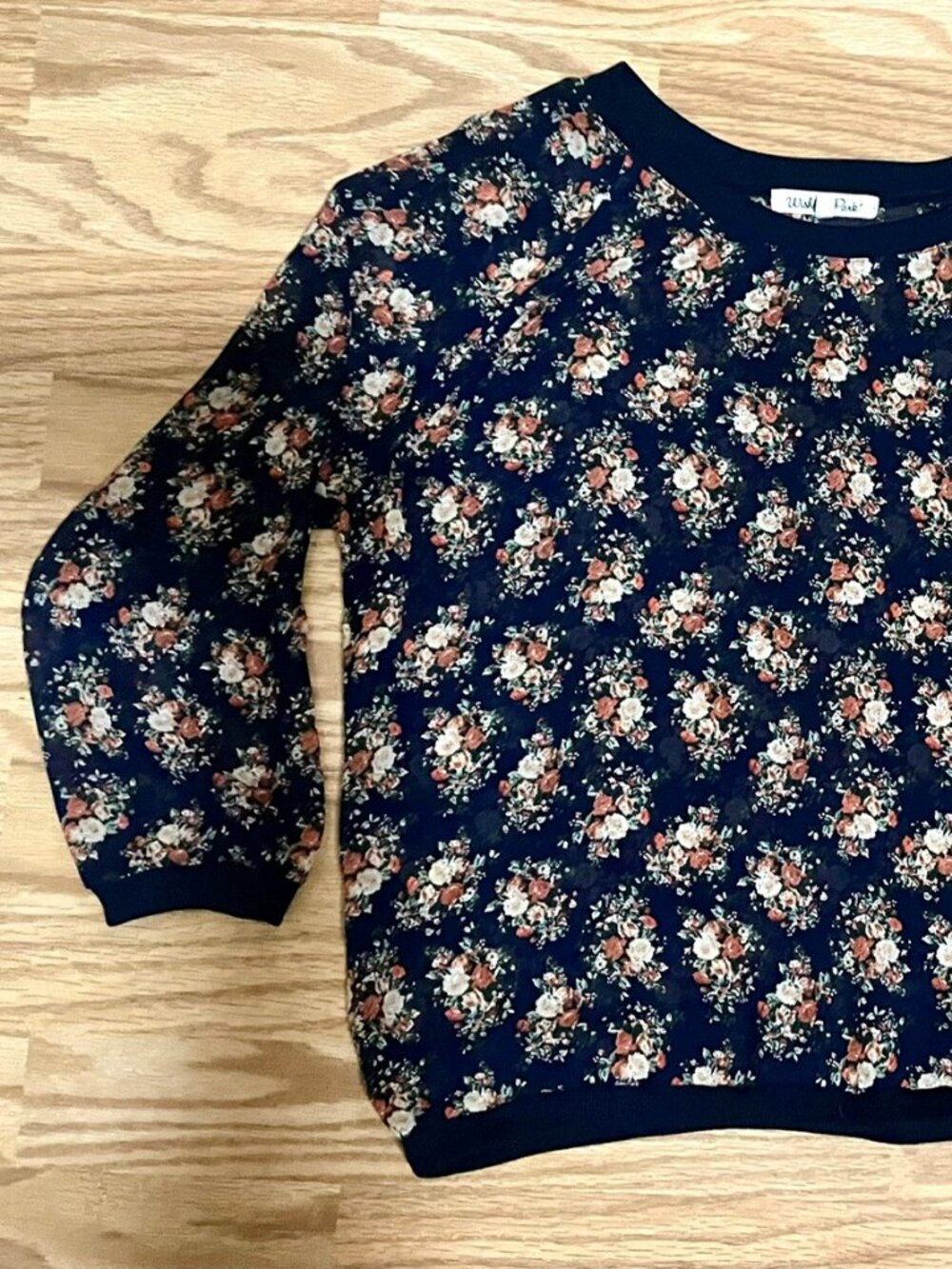 Wishful Park Sheer Navy Floral Crewneck Top Sheer navy crewneck top with an all-